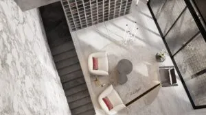 Vista cenital de un espacio interior de Karl Lagerfeld Residences en Bosque Real, con escaleras, mobiliario contemporáneo y acabados de mármol.