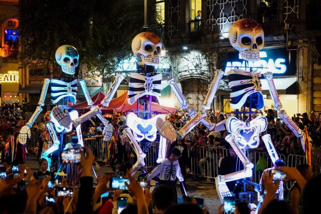Celebración del Día de Muertos en México con cempasúchil, altares y visitantes durante una temporada de mayor ocupación hotelera.